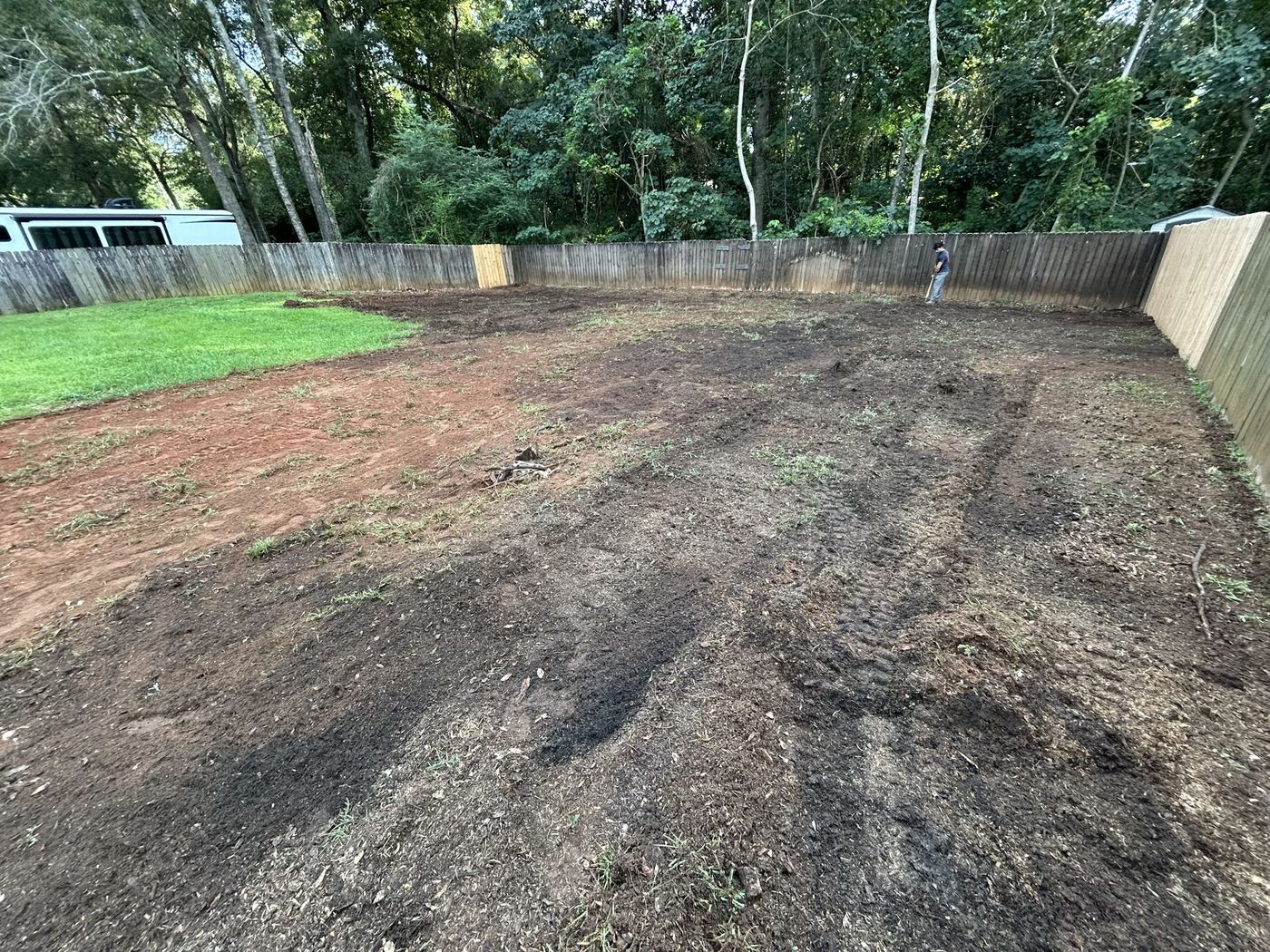 Before: the same backyard cleared to bare soil