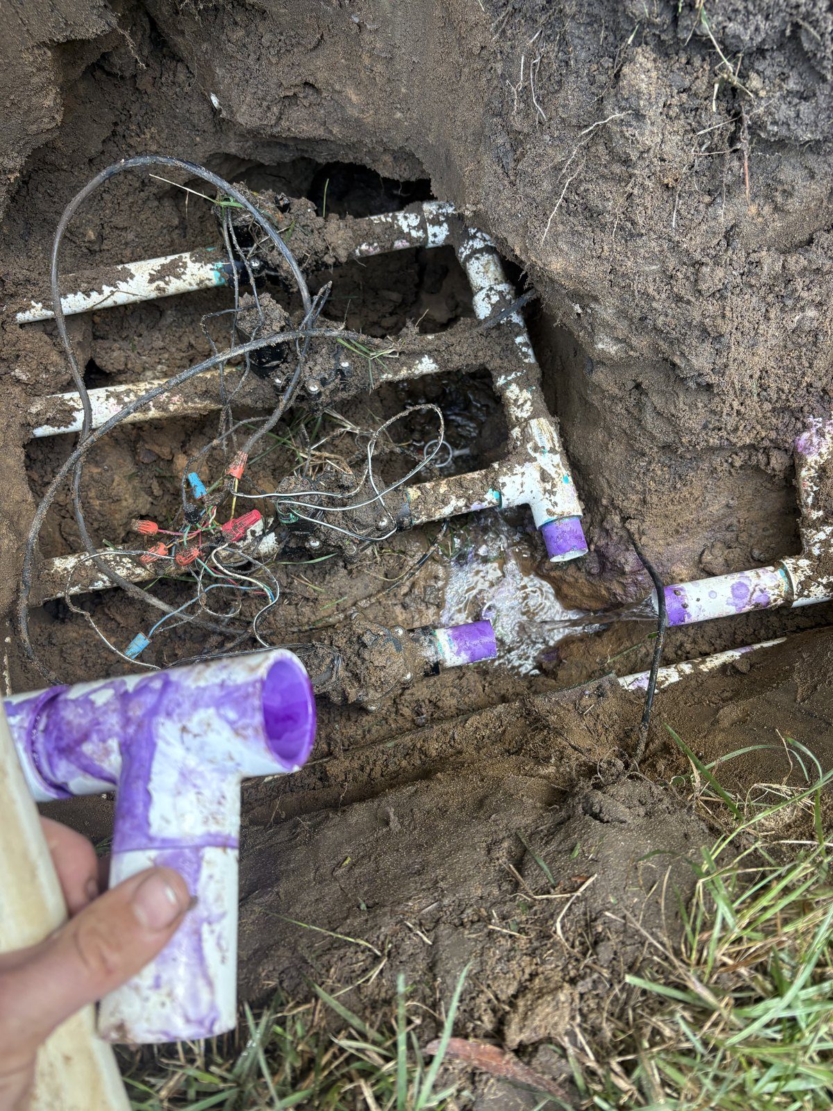 Irrigation valve manifold dug out and re-plumbed with new PVC fittings during a repair