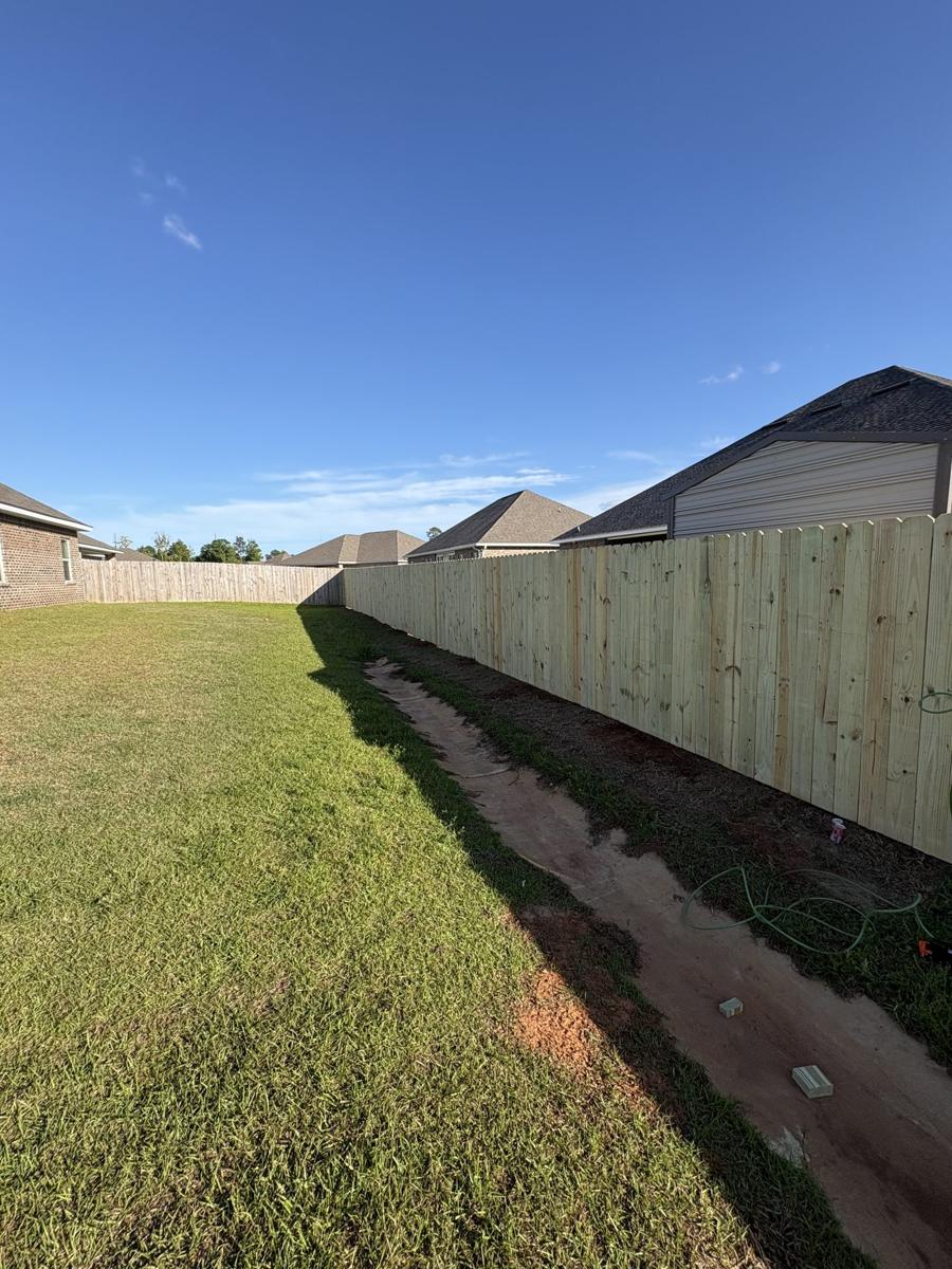New sod along a new wood fence line
