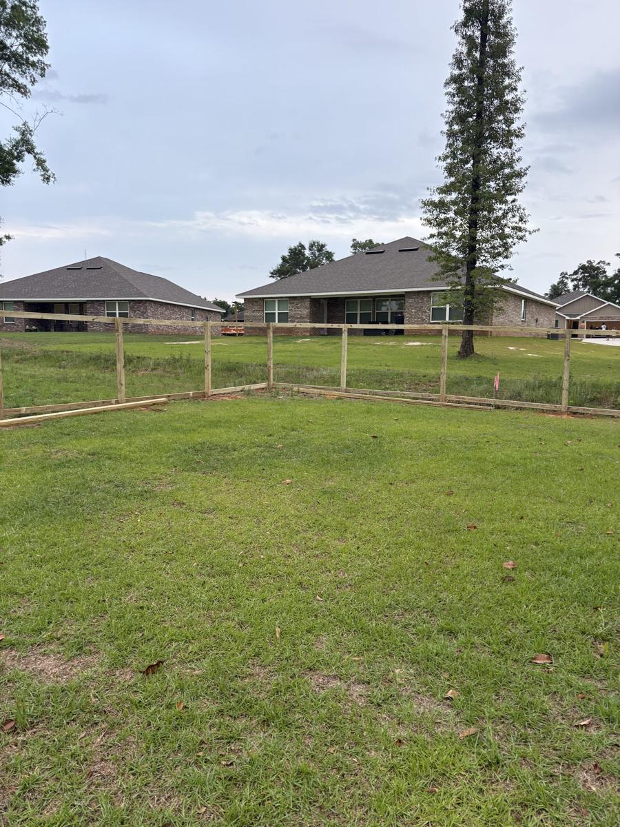 Wide new lawn inside a fenced yard